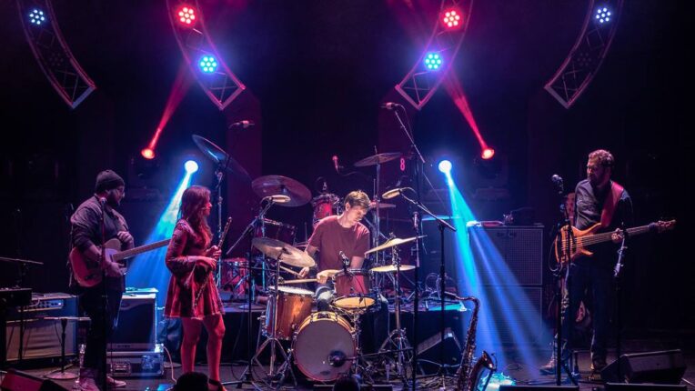 Band on stage with lights above