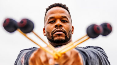 Man with arms in front holding percussion sticks