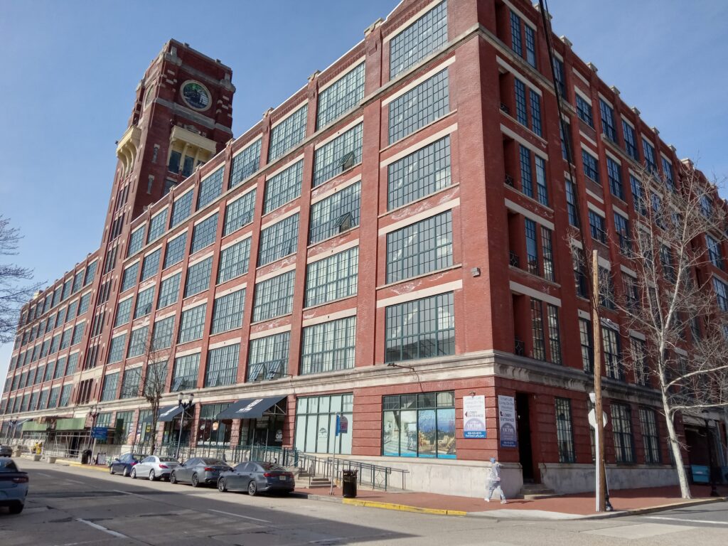 The headquarters of RCA Victor, a six story red brick building, with multi pane windows, in Camden, New Jersey.