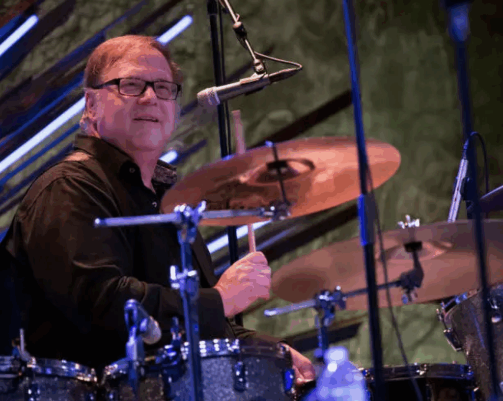 Drummer David Diken sits at a drum kit