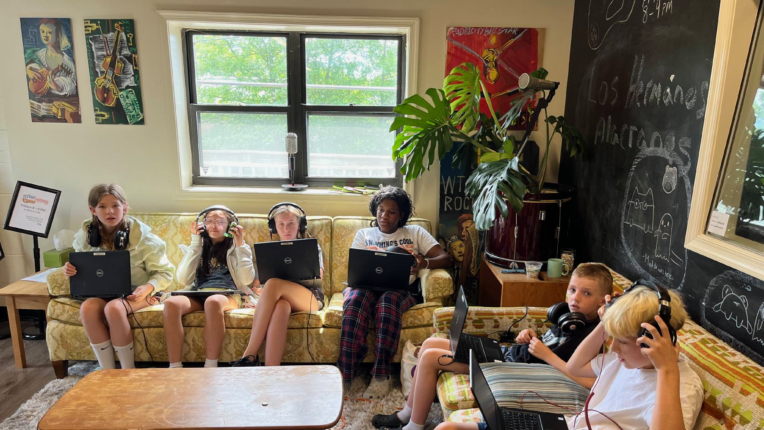 students sitting on couches with laptops