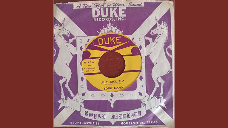 45 rpm reocrd with a purple and white cover that says Duke and has tow unicorns on either side of the record showing through the center