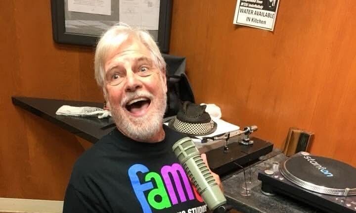 Man on knees in front of turntables