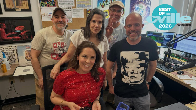 A team of five DJs smile at the camera in the WTJU Broadcast Studio