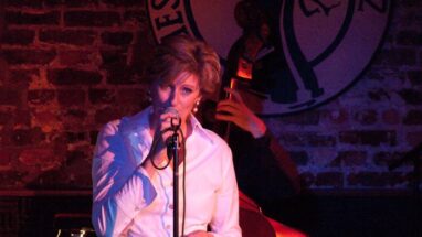 Dutch jazz vocalist Paulien on a stage singing in to a microphone