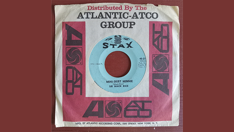 A 7 inch record with a blue center that says Stax, in a cover by the Atlantic record label.