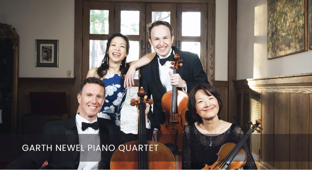 Four members of the Garth Newel Piano Quartet smile at the camera, two sitting, two standing, and three holding stringed instruments.